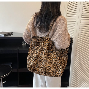 Detailed view of the large leopard print tote bag fabric and spacious shoulder strap