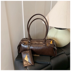 Detail of vintage brown leather bag with belt buckle decor and small chain purse