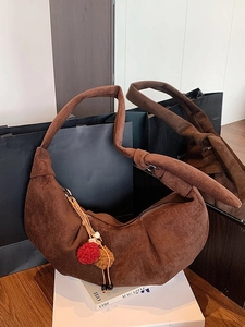 Retro dark brown suede crescent shoulder bag with knotted strap and tassel accessory