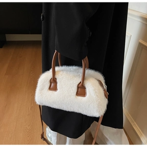 Chic white faux fur Boston bag with brown leather handles and adjustable shoulder strap