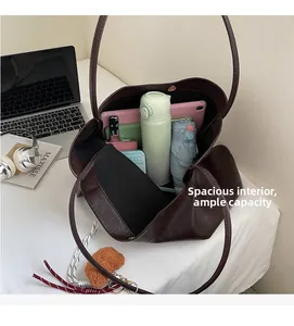 Spacious interior of dark brown tote bag showing capacity for tablet, umbrella and cup