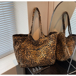 Detailed view of the leopard print tote bag with thick handles and outer pocket detail