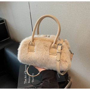 Close-up of fluffy apricot faux fur Boston bag with silver hardware and soft handles