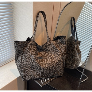 Detail view of large leopard print tote bag with functional front slip pocket
