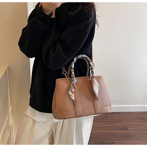 Brown lychee leather handbag with printed silk scarf detail and adjustable strap