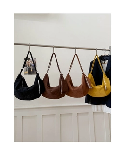 Detail showing high-capacity suede hobo bags in four colors with functional side pockets