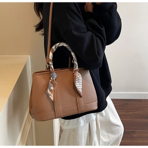 Brown lychee leather bucket bag with silk scarf handle and long shoulder strap