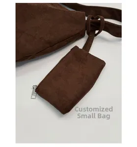 Detail of the matching suede pouch with silver zipper for the brown shoulder bag