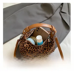 Leopard print crossbody bag interior showing phone and cosmetics storage space