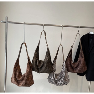 Detailed display of leopard print hobo bags in four colors with adjustable brown straps