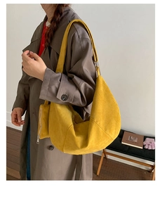 Detail of yellow suede crescent bag with adjustable wide strap and matching coin purse