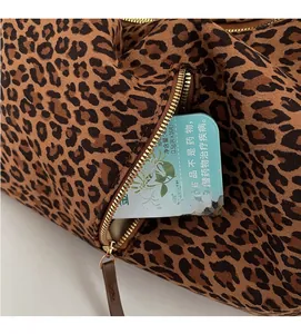 Detail of leopard print tote bag side zipper pocket and textured fabric finish