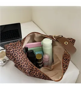 Macro view showing large capacity of leopard print suede bag with daily essentials inside