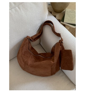 Detailed close-up of brown suede crescent hobo bag set with a small matching pouch