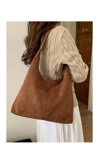 Brown suede tote bag styled with knit sweater for a minimalist autumn fashion look