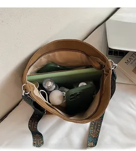 Interior view of large brown canvas tote bag showing spacious storage for tablet and makeup