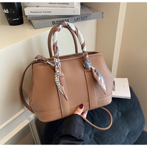 Brown lychee leather handbag detail with silk scarf handle and silver hardware