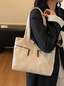 Off-white large canvas tote bag with dual front zipper pockets for daily commuting use