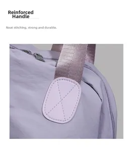 Detail of lavender nylon tote bag showing reinforced X-shaped stitching and silver zipper