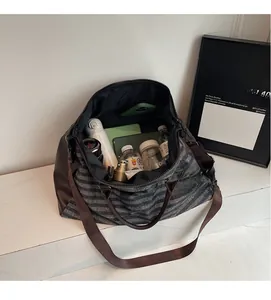 Interior detail of travel bag showing large capacity compartments and striped fabric lining
