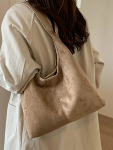 Brown soft suede hobo tote bag for women worn over shoulder with minimalist design