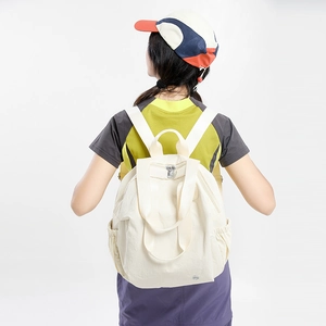 Rear view of a beige multifunctional backpack shown on a model with side pocket detail