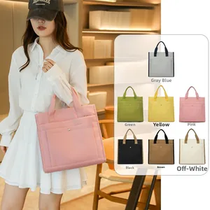 Collection of seven minimalist tote bags in various colors for stylish office commuting