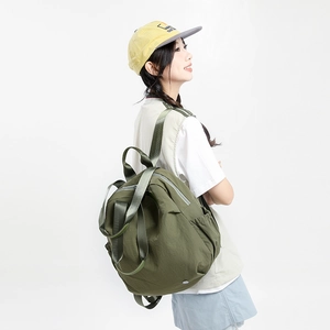 Detail view of army green nylon backpack showing durable fabric and adjustable wide strap