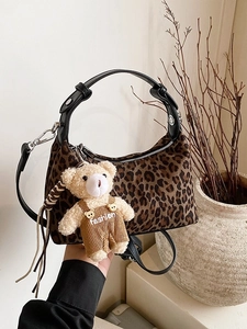 Leopard print dumpling handbag with cute plush bear charm and adjustable shoulder strap