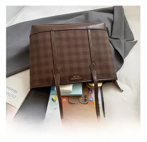 Detail showing internal capacity of brown checkered tote bag with daily essentials