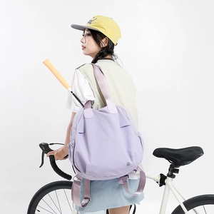 Detail view of light purple nylon multi-functional tote and backpack on a bike