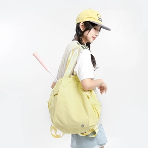 Detail of yellow sports backpack showing functional racket slot with a pink racket