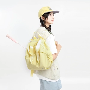 Side view of a light yellow nylon backpack on model, featuring elastic side pockets