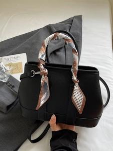 Fashionable black lychee grain leather handbag with printed silk scarf wrap on handle