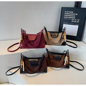 Detail showing suede and leather contrast textures on four elegant shoulder bags