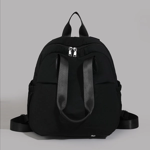 Detailed close-up of durable black nylon fabric, ergonomic straps and silver zipper on backpack