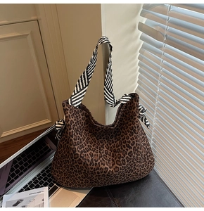 Détail du cabas léopard avec bandoulière rayée et décor de style de vie urbain chic