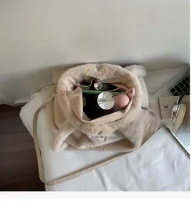 Vue détaillée de l'intérieur spacieux d'un sac cabas en peluche beige à fermoir
