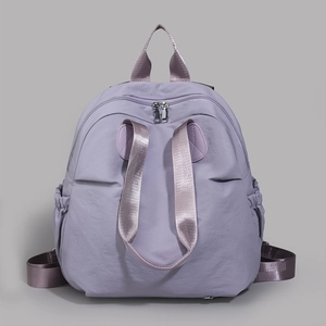 Detailed front view of light purple nylon backpack with durable waterproof fabric