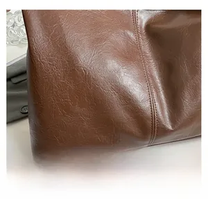 Close-up of vintage dark brown faux leather texture with durable double-stitch details