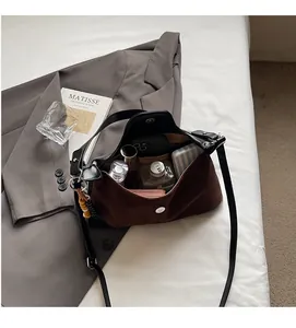 Detail of hobo bag interior showing spacious capacity for phone and cosmetics