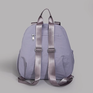 Rear view of lavender nylon backpack with adjustable straps and anti-theft zipper pocket
