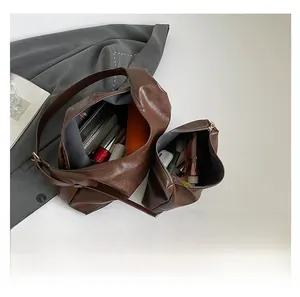 Interior view of large brown leather tote bag showing spacious capacity and organizer