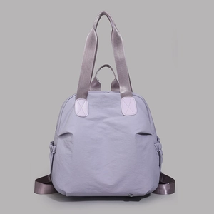 Detailed close-up of light purple water-resistant nylon fabric and tote bag handle