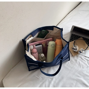 Interior view showing large capacity of the striped canvas tote bag with daily items