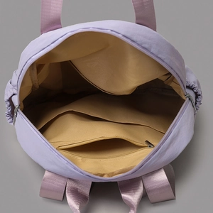 Detailed interior view of lilac multi-pocket tote bag with zipped compartment and lining