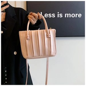 Pink pleated bucket handbag with double top handles and matching shoulder strap detail
