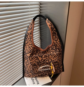 Detailed macro view of leopard print suede shoulder bag with Noronoro front pocket