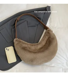 Fuzzy brown plush shoulder bag detail showing size comparison with a smartphone