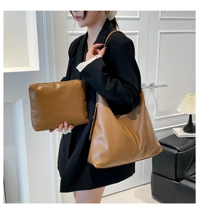 Detail of caramel brown faux leather hobo bag and matching square zipper pouch set